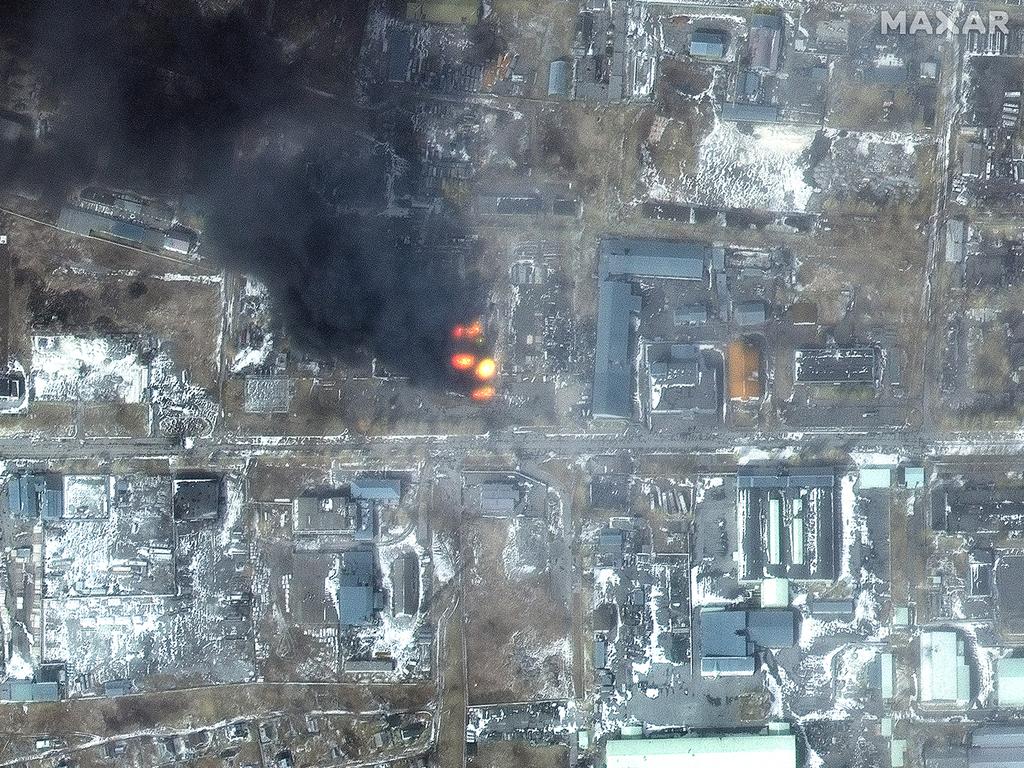 Black smoke and flames can be seen billowing from buildings. Picture: Maxar Technologies