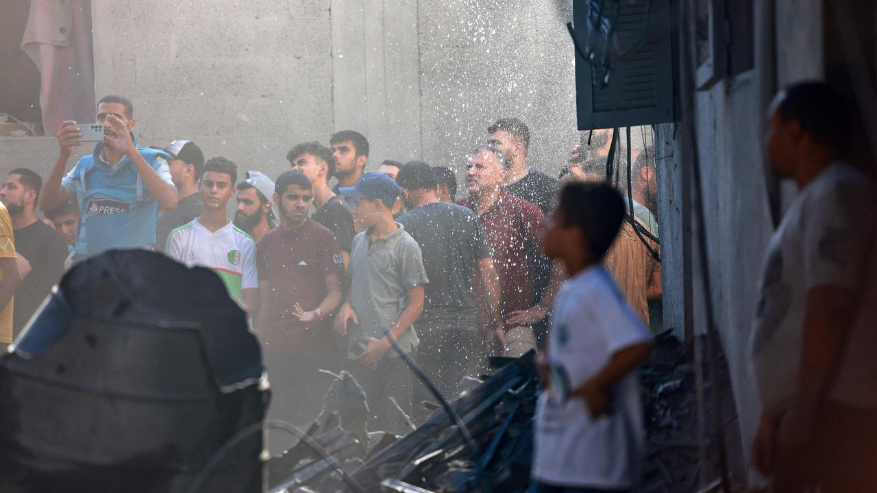 Palestinians gather at the scene of a strike at the Nuseirat refugee camp. Picture: AFP