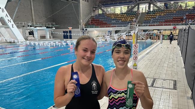 50m backstroke winner Ava Crase, left, with Mary MacKillop's Isla O'Brien.