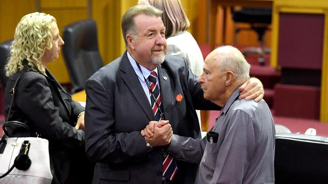 Cr Paul Tully (left) is seen following the Ipswich City Council's final meeting at the Ipswich City Council Chambers in Ipswich, Monday, August 20, 2018. The Queensland government will on Tuesday introduce laws to sack the entire council and appoint administrators after a corruption probe saw 15 people, including two former mayors, charged with 86 offences. (AAP Image/Dave Hunt) NO ARCHIVING