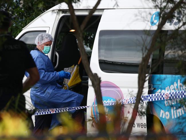 Police officers attend Hambledon State School at Edmonton, where a 3 year old was found dead in a Goodstart Early Learning Centre minibus at around 3:30pm on Tuesday. A police forensic officer inspects the van. PICTURE: BRENDAN RADKE