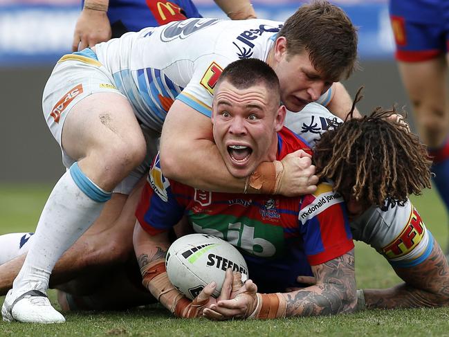 David Klemmer of the Knights is tackled by Jai Arrow and Kevin Proctor of the Titans during the Round 24 NRL match between the Newcastle Knights and the Gold Coast Titans at McDonald Jones Stadium in Newcastle, Saturday, August 31, 2019.  (AAP Image/Darren Pateman) NO ARCHIVING, EDITORIAL USE ONLY