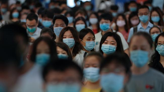 People wearing face masks walk in a subway station during morning rush hour on July 20 in Beijing, China. Picture: Getty