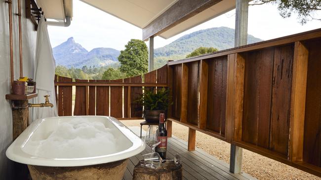 An old clawfoot bath is perfectly positioned to frame mountain views at Mt Warning Estate.