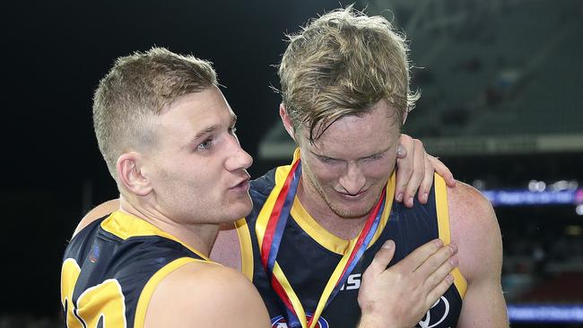 Adelaide’s Rory Laird congratulates Alex Keath after he won the showdown medal. Picture Sarah Reed