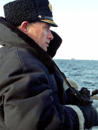 Putin looks out of a nuclear submarine Karelia, in the Barents Sea, in Severomorsk, in 2000.