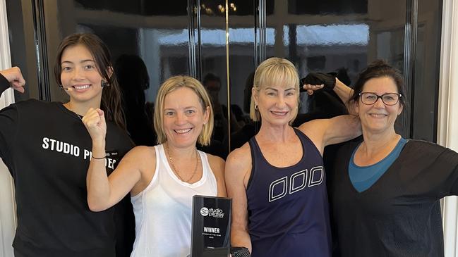 Mitsuki Furutani-Burns, Ange Seymour, Chrissie Ford, Sue O’Donnel with the trophy awarded to them for being judged the best Studio Pilates International franchise in the world.