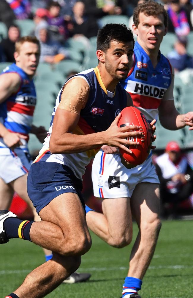 Crow Wayne Milera on the run against his former team, Central District, in the elimination final. Picture:  Tom Huntley