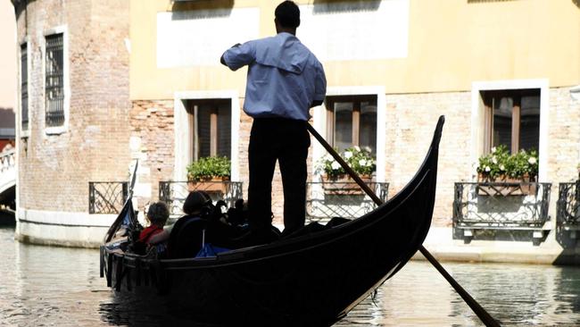 A gondolier rows his gondola in a canal in Venice. Picture: Supplied