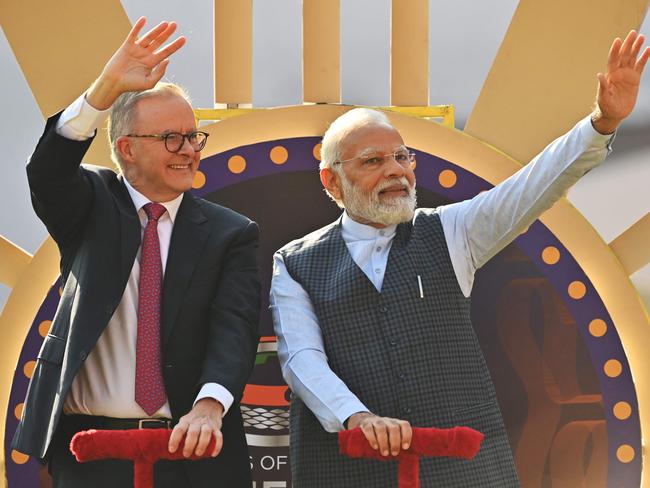 Indian Prime Minister Narendra Modi (R) and Australia's Prime Minister Anthony Albanese (L) wave to spectators at the Narendra Modi stadium in Ahmedabad on March 9, 2023, before the start of the fourth and final Test cricket match between India and Australia. (Photo by Punit PARANJPE / AFP) / ----IMAGE RESTRICTED TO EDITORIAL USE - STRICTLY NO COMMERCIAL USE-----