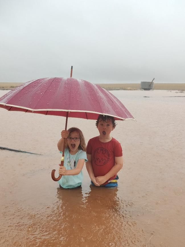 Addison, 6 and Hunter, 8, in the floodwaters on their family’s property near Kimba. Picture: Libby Baldock