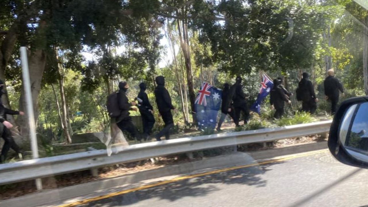 A group of men dressed in black and carrying Australian flags protesting in Ipswich. Picture: Reddit