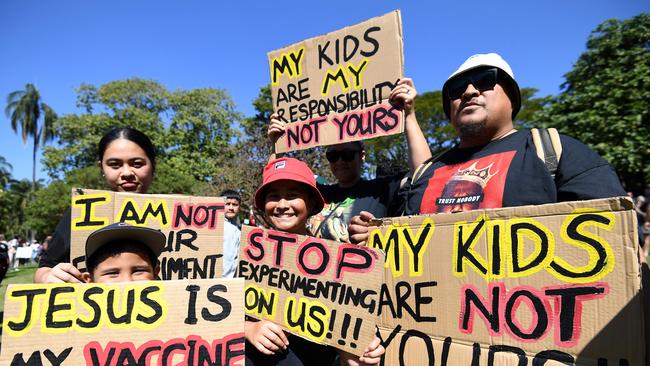 BRISBANE, AUSTRALIA - NewsWire Photos - AUGUST, 21, 2021A family holds signs as people gather for a protest to rally for freedom of speech, movement, choice, assembly, and Health in Brisbane. Picture: NCA NewsWire / Dan Peled