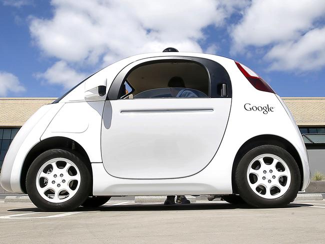 In this May 13, 2015 photo, Google's new self-driving prototype car is presented during a demonstration at the Google campus in Mountain View, Calif. The car, which needs no gas pedal or steering wheel, will make its debut on public roads this summer. (AP Photo/Tony Avelar)