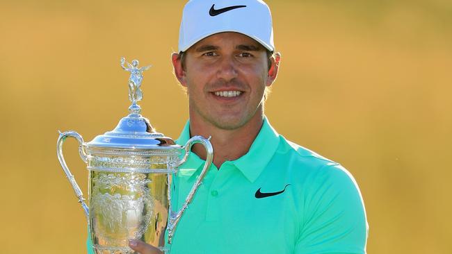 Brooks Koepka of the United States poses with the winner's trophy.