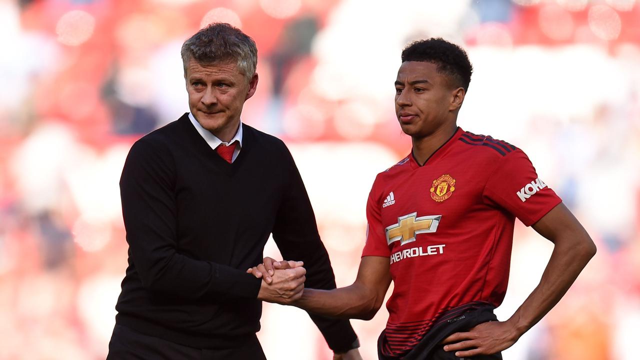 Manchester United midfielder Jesse Lingard (R) shakes hands with manager Ole Gunnar Solskjaer (L)