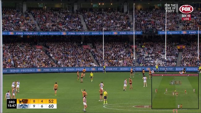 Jack Gunston and Tom Mitchell use their arms near the umpire. Photo: Kayo.