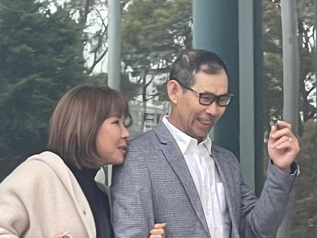 All smiles: Crop sitter Chuyen Van Ta, 55, of Edmondson Park, leaving court with a woman after he was sentenced. Picture: NewsLocal