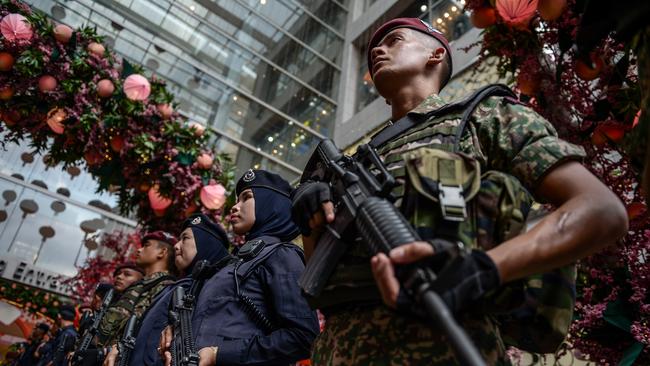 Members of the police and army stand guard in Kuala Lumpur.