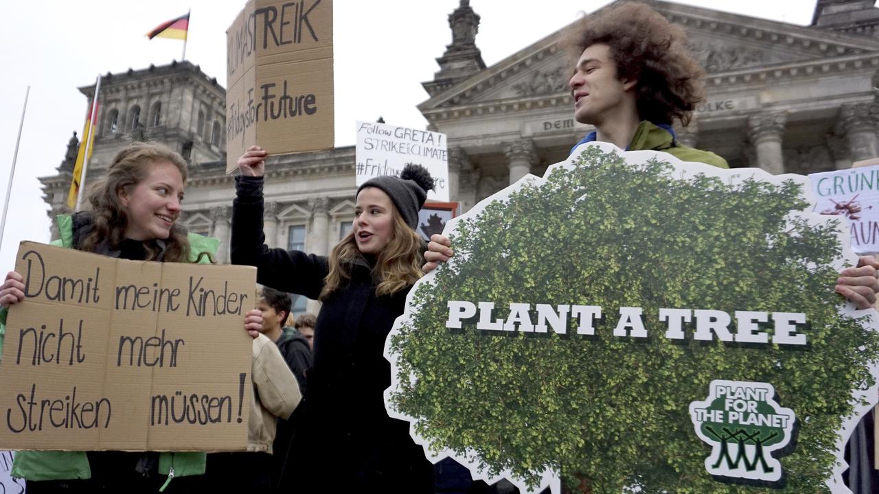 Students protest under the banner of 'Fridays for Future' in front of the Reichstag building, host of the German federal parliament, in Berlin, Germany. Picture: AP 