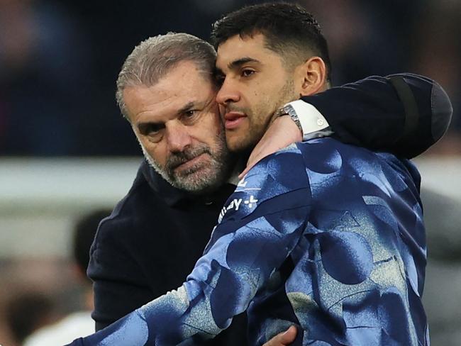 Tottenham Hotspur's Greek-Australian Head Coach Ange Postecoglou (L) celebrates with Tottenham Hotspur's Argentinian defender #17 Cristian Romero (R) on the pitch after the English Premier League football match between Tottenham Hotspur and Aston Villa at the Tottenham Hotspur Stadium in London, on November 3, 2024. Spurs won the game 4-1. (Photo by Adrian Dennis / AFP) / RESTRICTED TO EDITORIAL USE. No use with unauthorized audio, video, data, fixture lists, club/league logos or 'live' services. Online in-match use limited to 120 images. An additional 40 images may be used in extra time. No video emulation. Social media in-match use limited to 120 images. An additional 40 images may be used in extra time. No use in betting publications, games or single club/league/player publications. /