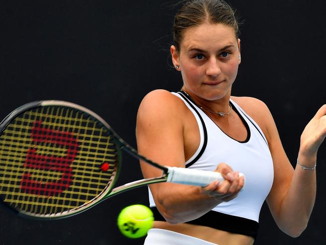 Ukraine's Marta Kostyuk hits a return against Amanda Anisimova of the US during their women's singles match on day one of the Australian Open tennis tournament in Melbourne on January 16, 2023. (Photo by Paul CROCK / AFP) / -- IMAGE RESTRICTED TO EDITORIAL USE - STRICTLY NO COMMERCIAL USE --