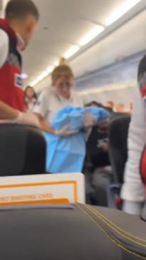 Incredible moment woman gives birth on plane