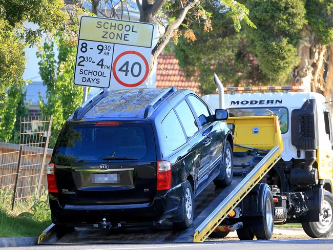 A car is taken away on a tow truck after the boy was found. Picture: Mark Stewart