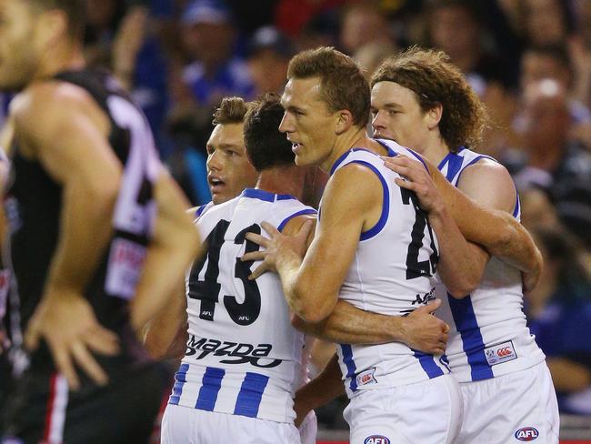 North Melbourne celebrates a slender win.