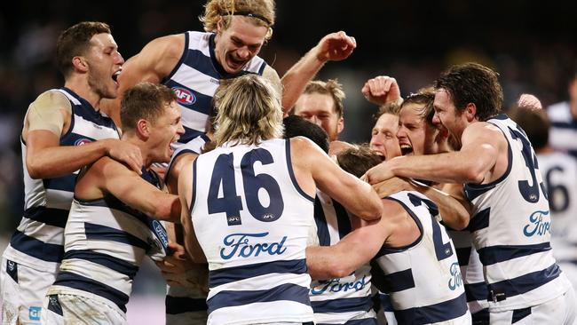 Geelong players mob Zach Tuohy after his matchwinner against Melbourne. Picture: Michael Klein