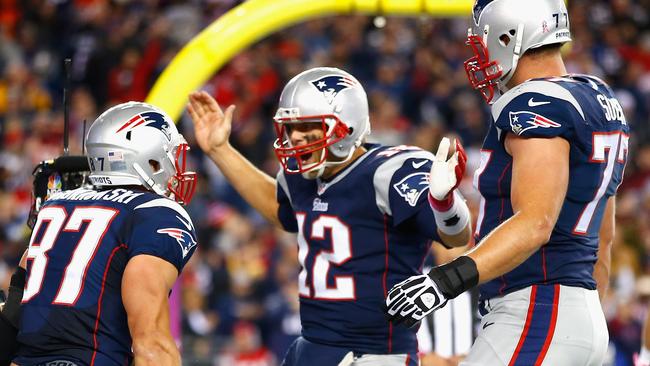 Tom Brady celebrates with Rob Gronkowski and Nate Solder.