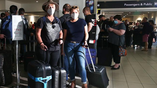 Lisa Cushen and Susan Charlewood line up to check in for their flight. Picture: Brendan Radke