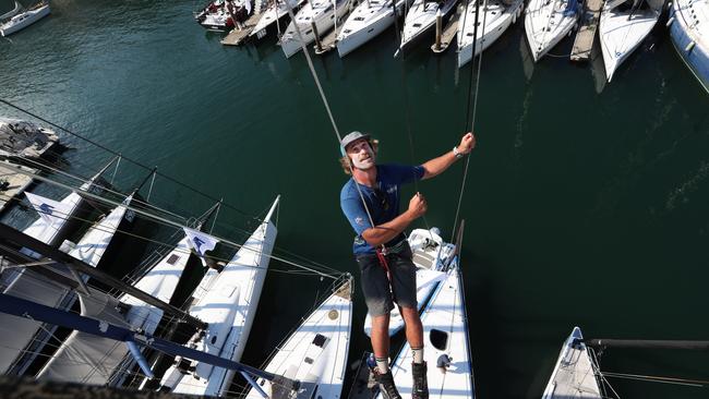 Warrior Won bowman, Dylan Vogel, 30, from Rhode Island up the mast at the CYCA ahead of the Sydney to Hobart on Monday. Picture: John Feder/The Australian.