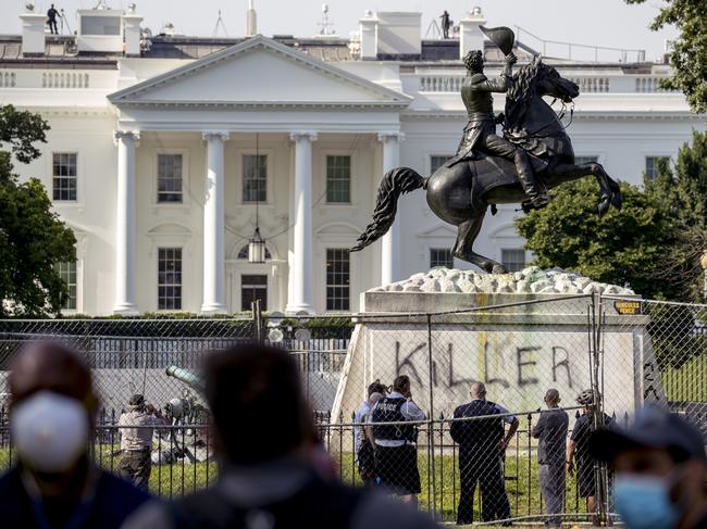 The White House is visible behind a statue of President Andrew Jackson in Lafayette Park in Washington, with the word "Killer" spray painted on its base. Picture: Andrew Harnik