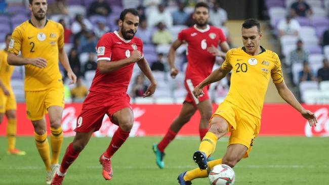 Australia's defender Trent Sainsbury, right, fights for the ball with Jordan's forward Baha Faisal. Picture: AFP