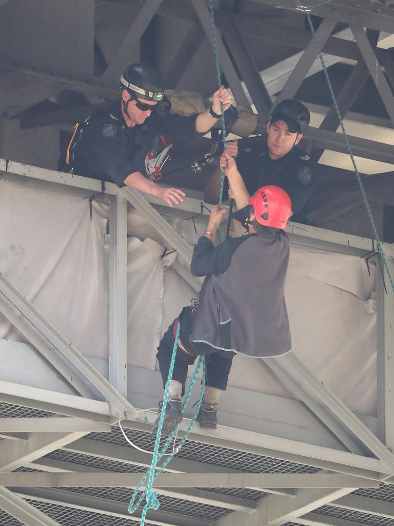 The protestor is retrieved by police. Picture: Peter Wallis