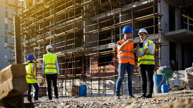 Four construction workers having meeting