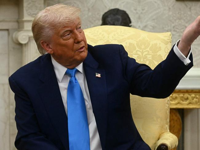 US President Donald Trump gestures as he meets with South African President Cyril Ramaphosa in the Oval Office of the White House in Washington, DC, on May 21, 2025. South African President Cyril Ramaphosa meets Donald Trump on Wednesday amid tensions over Washington's resettlement of white Afrikaners that the US president claims are the victims of 