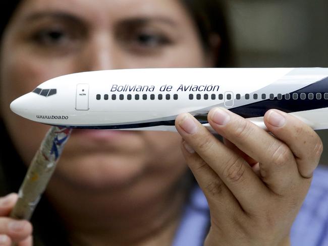 In this Feb. 5, 2015 photo, Diocelina Barajas applies decals to a model plane at Pacific Miniatures in Fullerton, Calif. When airlines open new routes, make deals with other carriers or finance new jets, there is a gifting of high-quality models. They are used to break the ice at difficult meetings, are tremendous marketing tools and a favored way of saying thank you. (AP Photo/Chris Carlson)