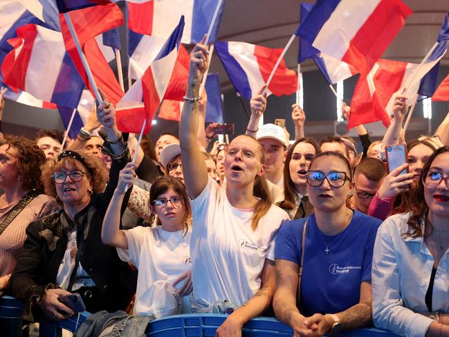 National Rally supporters wave the national flag of France during a campaign meeting in May. Picture: Francois Lo Presti/AFP