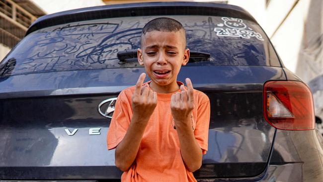 A boy reacts as he mourns the loss of his child sister who was killed in the aftermath of overnight Israeli bombardment. Picture: AFP