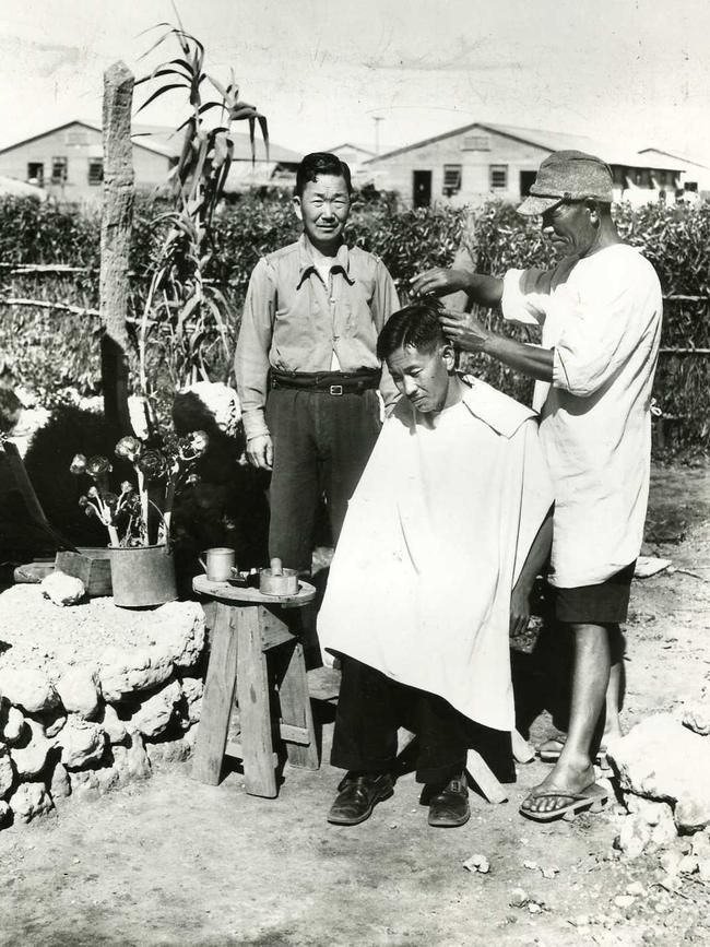 Detainees having their hair cut at the Loveday internment camp 1946.