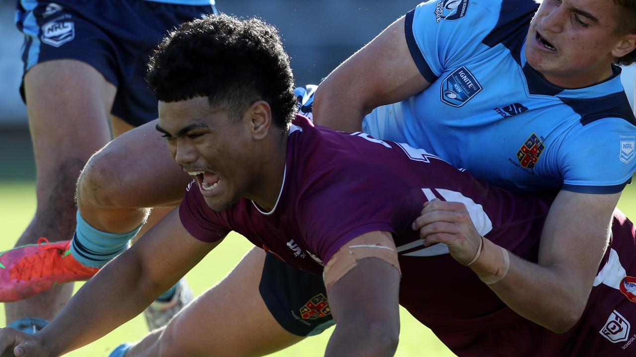 QLD's Karl Oloapu scores a try whilst NSW's Chevy Stewart attempts to tackle during the under 18 ASSRL schoolboy rugby league championship grand final between QLD v NSW CHS from Moreton Daily Stadium, Redcliffe. Picture: Zak Simmonds