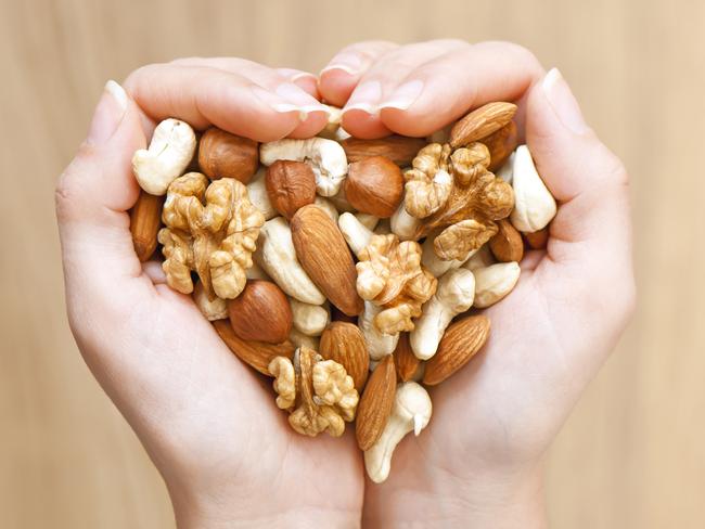 GCB Good Health Guide advertising feature - generic - Various nuts in hands forming heart shape