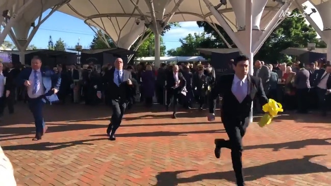 Melbourne Cup attendees storm into Flemington race track