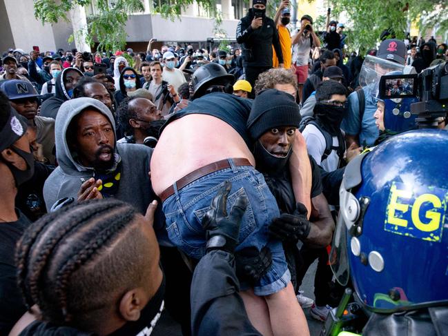 LA group of men carry an injured man away after he was allegedly attacked near Waterloo station. Picture: Getty Images