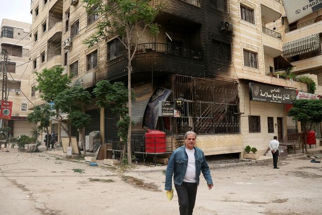 A partly burnt building after clashes in Sahnaya near Damascus