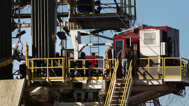 Workers stand on the platform of a fracking rig in the Permian Basin oilfield in Texas. Picture: AFP