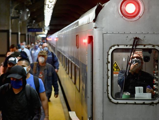 TOPSHOT - Commuters arrive at Grand Central Station with Metro-North during morning rush hour on June 8, 2020 in New York City. - Today New York City enters "Phase 1" of a four-part reopening plan after spending more than two months under lockdown. New York City is the final region in the state to reopen its economy. (Photo by Angela Weiss / AFP)