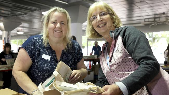 Raising Literacy Australia volunteers Kylie Meakins and Sandy Mehaffey pack 65,000 reading packs for children across South Australia in 2019. Picture: AAP Image/Dean Martin